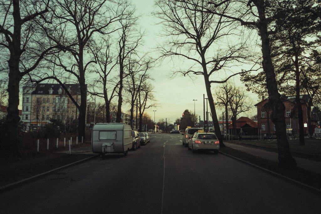 Peaceful urban street in Berlin with bare trees lining the road during winter.